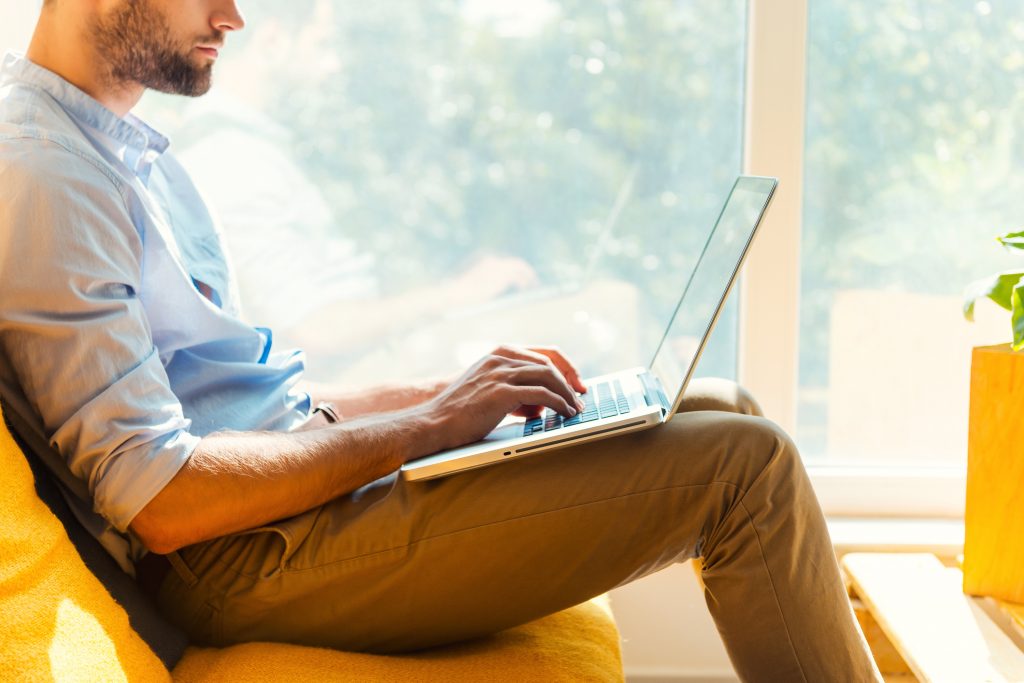 young man on laptop looking at mmj website