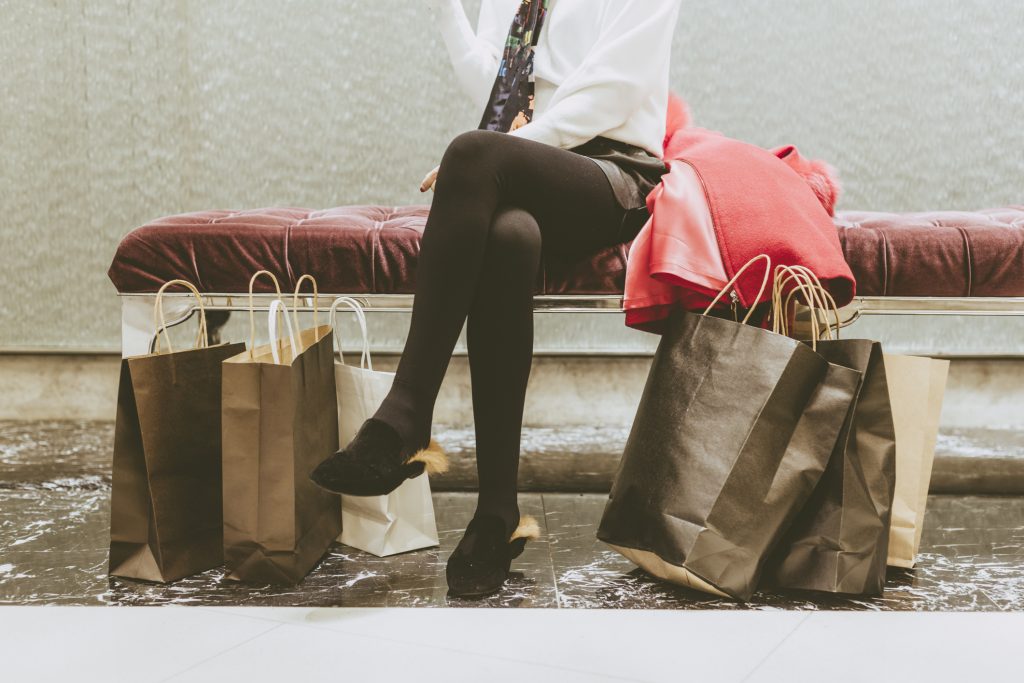 Woman sitting on a bench after going shopping
