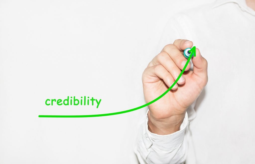 Businessman whiteboarding a credibility graph